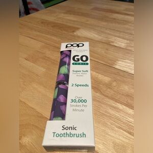 Pop Sonic portable Go Sonic toothbrush.Brand new in box. Cute purple design